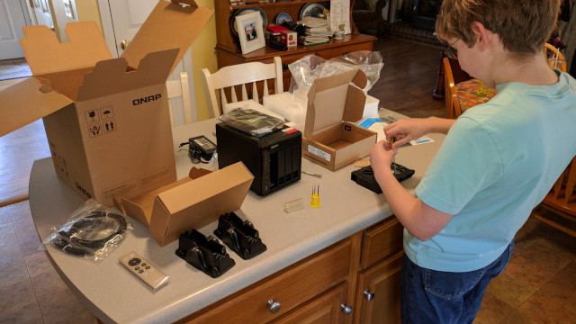 Timothy installing the drives into the QNAP